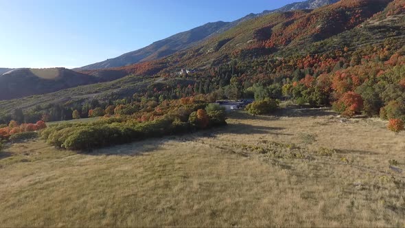 A drone flies over a mountain meadow near Dry Creek Trailhead in Alpine, Utah as leaves change into