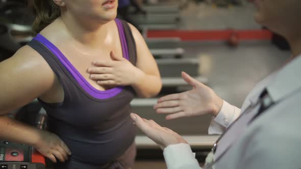 Female Doctor Consulting Overweight Woman, Helping Her to Recover After Workout