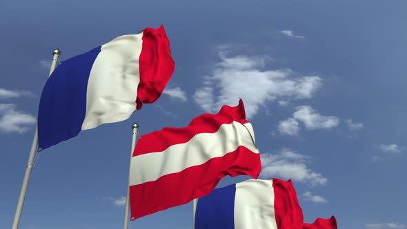 Waving Flags of Austria and France on Sky Background alt