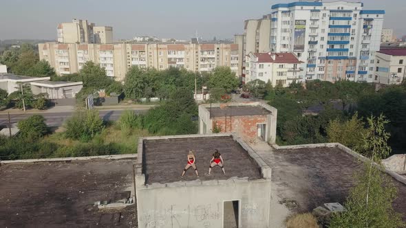 Two Girls Dance Twerk on the Roof of an Abandoned Building