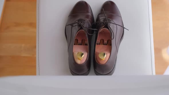 Groom Wedding Shoes Lying on a Chair.