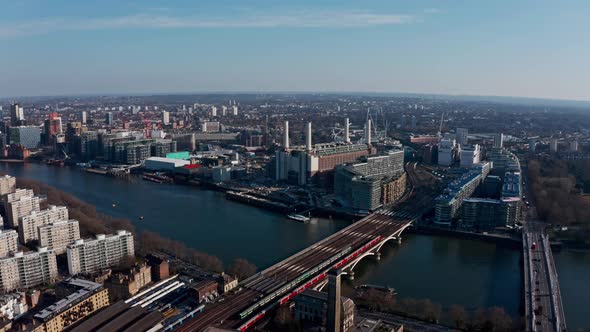 High circling drone shot around Battersea Power station on a beautiful sunny day