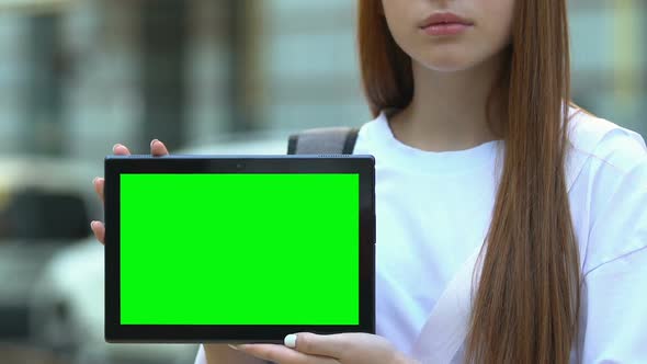 Female Student Holding Green Screen Tablet, Exchange Program App, Homework