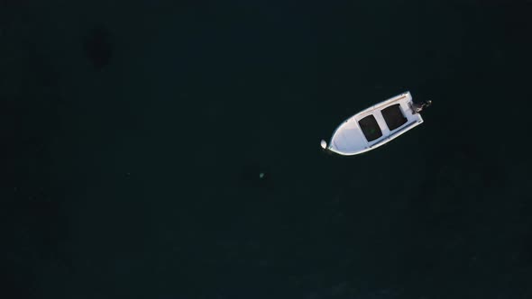 Aerial view of white Boat in the Sea. Flying above Boat. Alone boat in the Ocean 