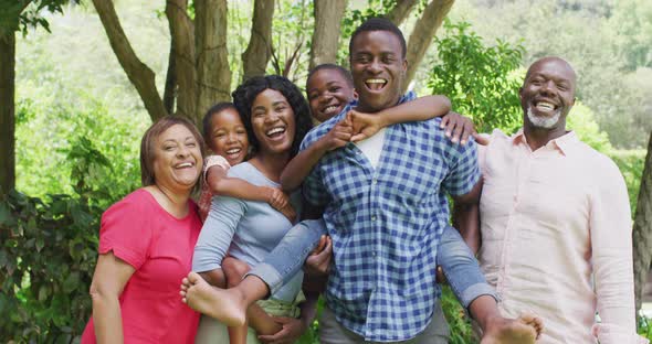 Happy african american multigeneration family posing to photo in garden