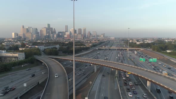 Aerial view over traffic on freeway near downtown Houston. This video was filmed in 4k for best imag