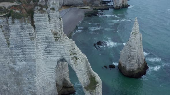 Incredible Aerial Overhead Aerial View of Etretat Cliff Arch in France with Sea Gulls Flying By