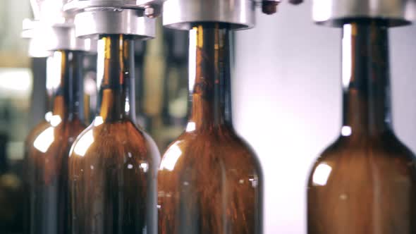 Bottles Being Filled with Red Wine at a Winery