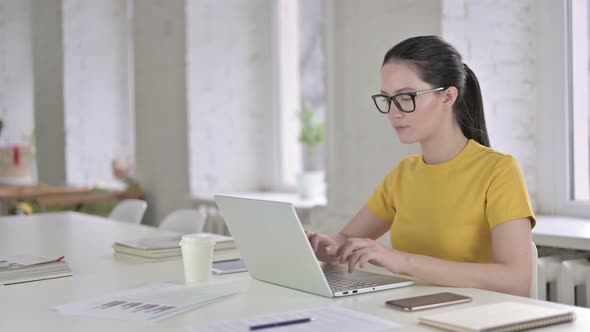 Sick Young Female Designer Coughing in Modern Office