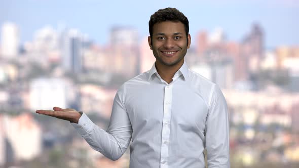 Handsome Businessman Presenting Something in His Palm