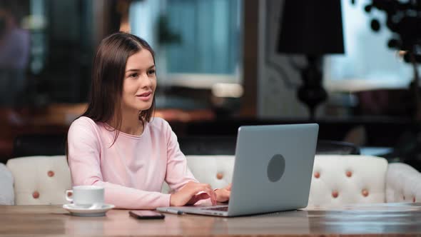 Smiling Pensive Freelancer Woman Working Remotely Use Laptop at Cafeteria