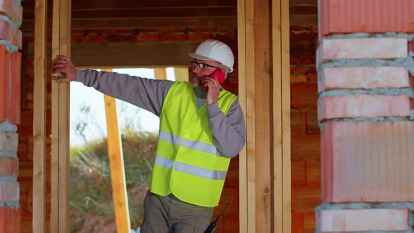 Architect Engineer Using Mobile Cell Phone Communications Control Process on Construction Site