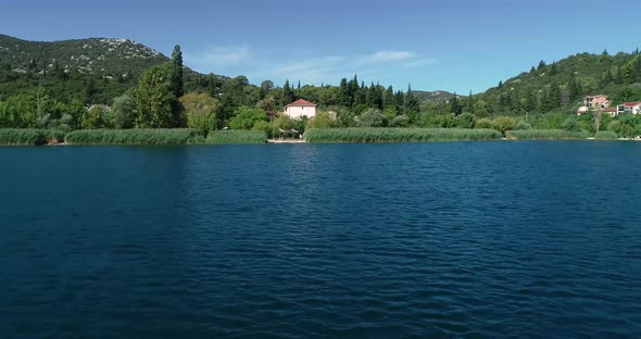 Aerial view of kitesurfing spot on the Neretva delta valley river.