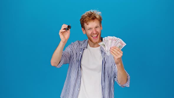 Happy Redhead Man Shows Money Cash and Key to Own Car
