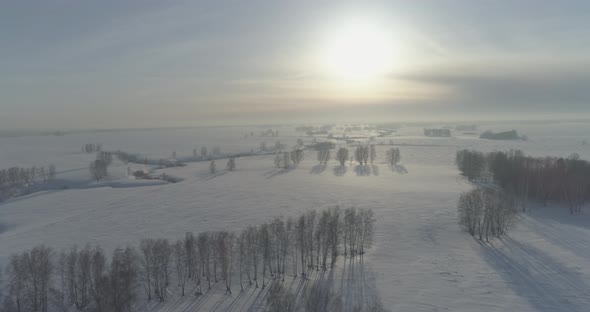 Aerial View of Cold Winter Landscape Arctic Field Trees Covered with Frost Snow Ice River and Sun