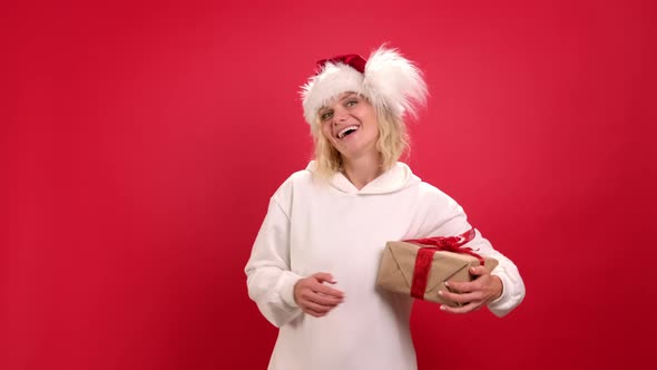 Christmas Holidays Sales and Shopping Portrait of Cheerful Woman in Santa Hat with Present Box Ask