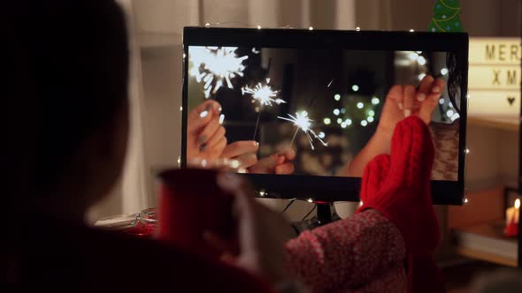 Young Woman Watching Tv at Home on Christmas