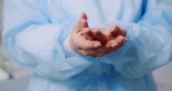 Doctor Disinfecting Hands with Bactericidal Gel