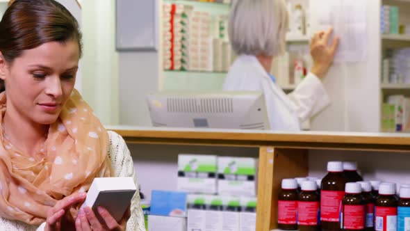 Customer holding a medicine box in pharmacy