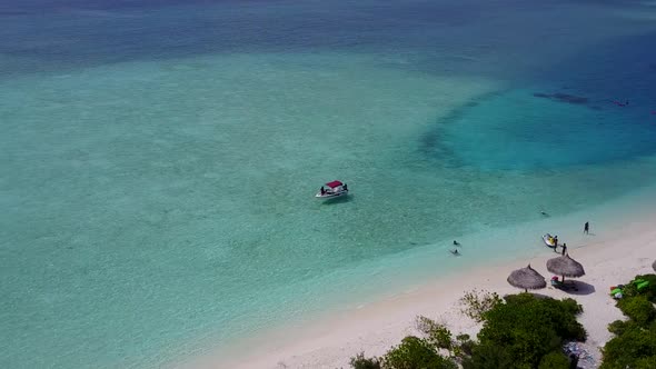 Sunny seascape of exotic seashore beach journey by blue water with sand background in sunlight