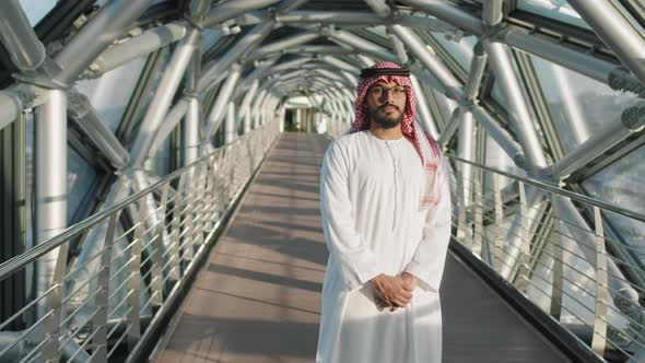 Middle-Eastern Man Standing At Glass Bridge