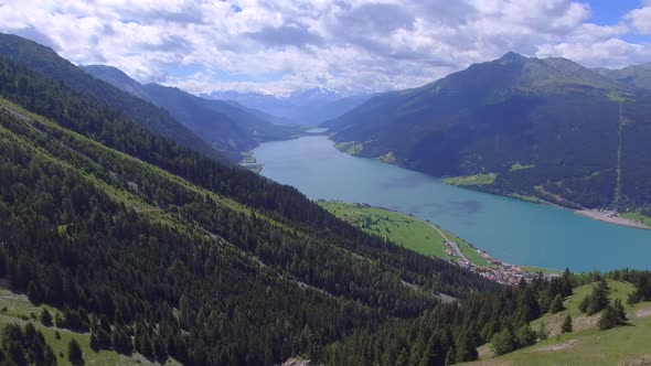 Aerial view of mountains green hills and a lake