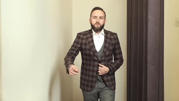 Stylish Young Man In Clothing Store Posing In New Suit.