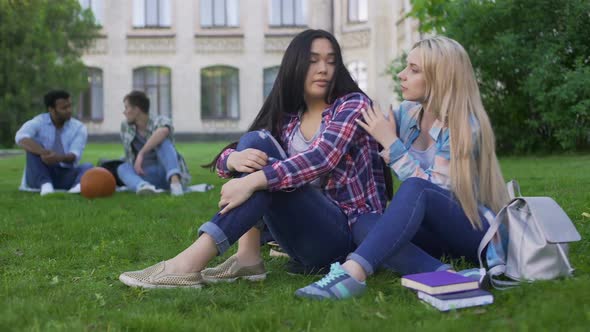 Best Female Friends Sitting on Grass and Discussing Teenage Problems, Support