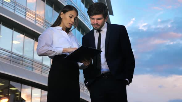 Elegant Woman Secretary Showing Documents To Her Boss Giving Brilliant Ideas.