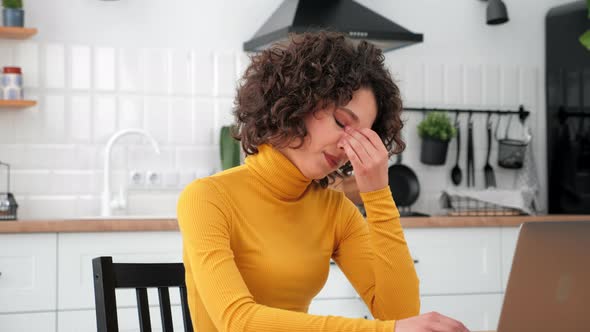 Tired Hispanic Curly Woman Uses Laptop Rubs Eyes After Long Hard Work Computer