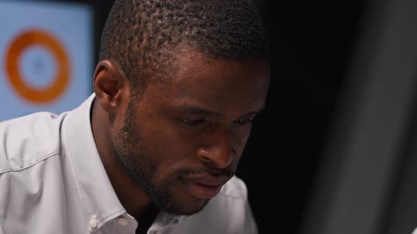 Serious afro american man working on business planning with colleague