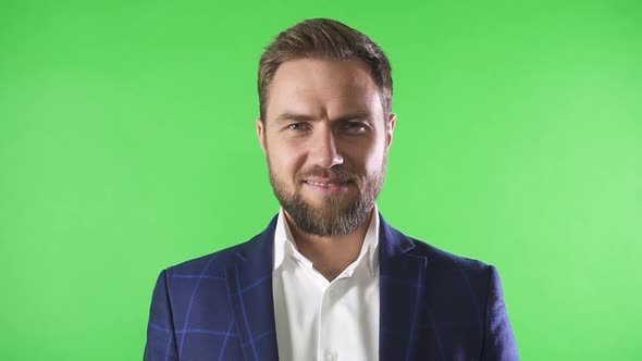 Portrait of Confident American Businessman Watching in Camera Posing on Background Green Wall