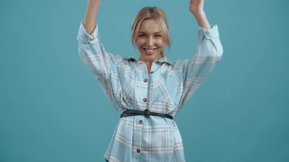 Cheerful Woman with Her Hands in Her Face Surprised Looks in the Room Then Celebrates the Victory