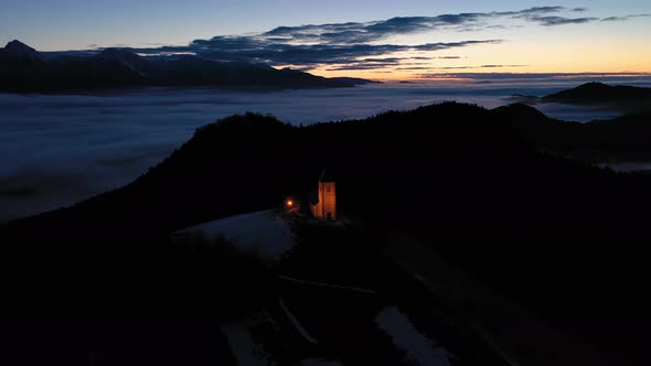 Church of St. Primoz and Felicijan in the Morning. Jamnik, Slovenia. Aerial View