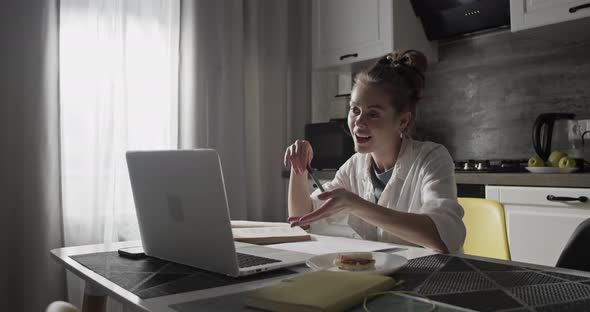 Young Woman During Online Lesson in Kitchen