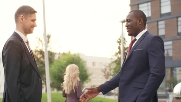 Smiling Multiethnic Businessmen Shaking Hands