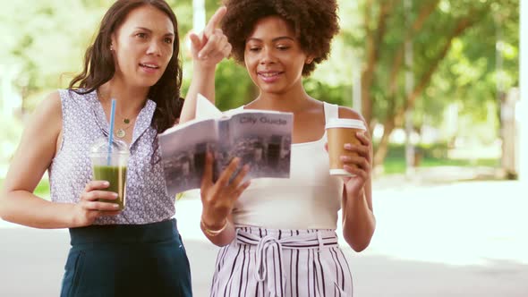 Women with City Guide and Drinks on Street