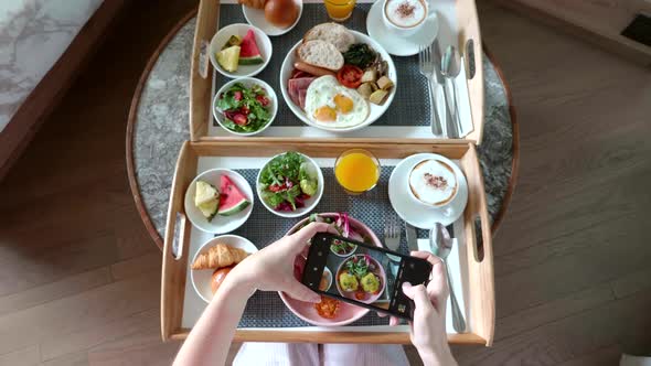 Female Hands Photographing Breakfast Food By Smartphone in Hotel Room