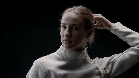 A Young Pretty Woman Fencer Lets Her Hair Down