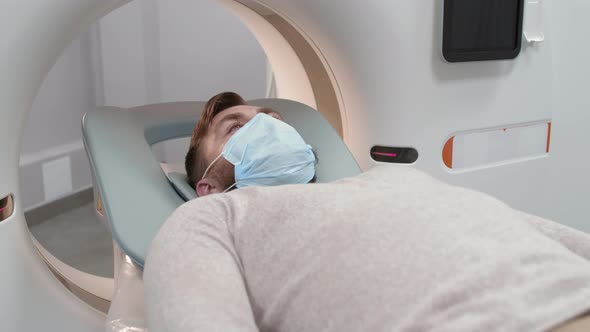 Patient in Face Mask Undergoing CT Scan