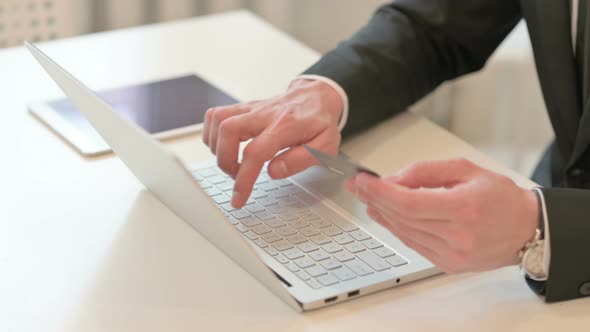 Top View of Middle Aged Businessman Making Online Payment on Laptop