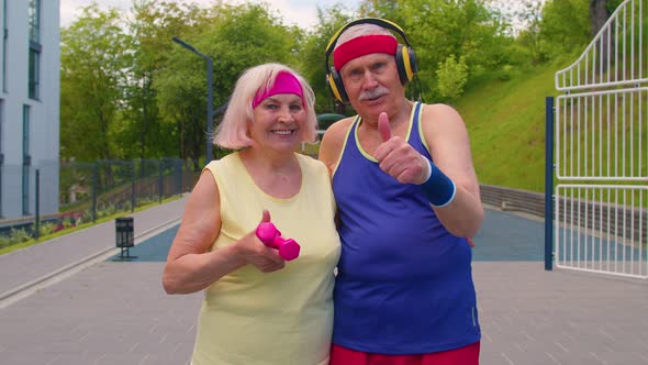 Active Elderly Man Woman After Sport Weightlifting Dumbbells Exercises Smiling Looking at Camera