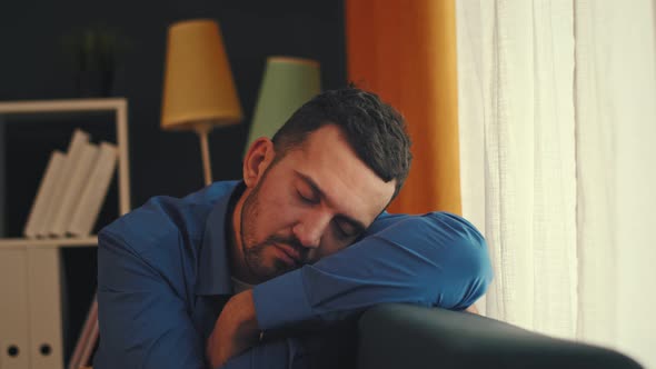 A Young Man Fell Asleep at Home By the Window While Waiting