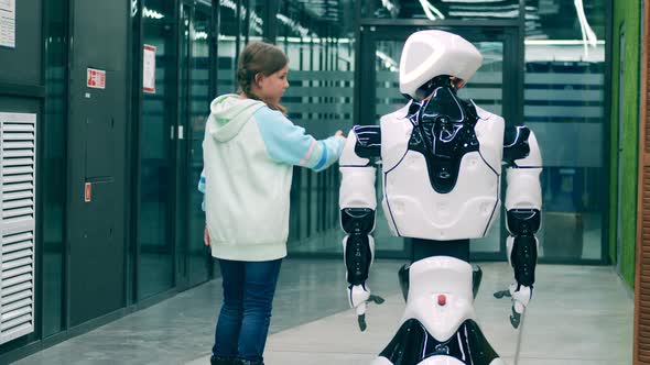 A Girl Is Being Excited While Talking To a Bionic Robot Modern Friendly Cyborg