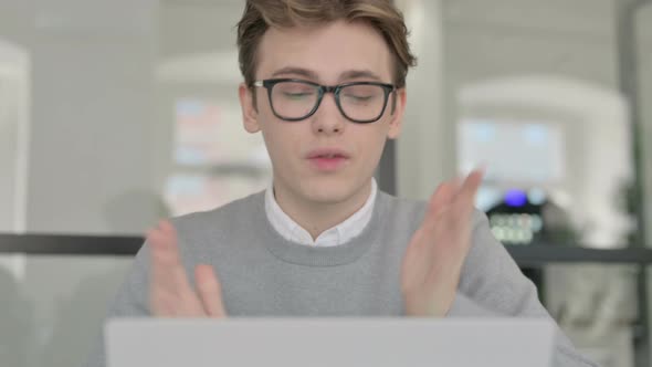 Close Up of Young Man Talking on Video Chaton Laptop