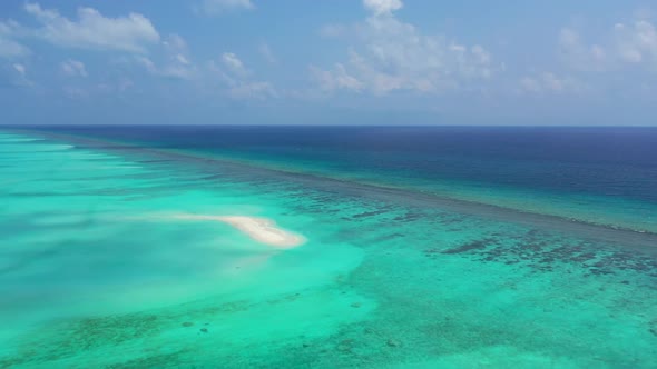 Aerial top down travel of idyllic island beach trip by blue green sea with white sandy background of