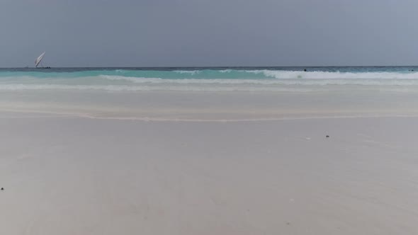 Landscape of Beautiful Tropical Beach with Tidal Waves and Blue Sky Zanzibar