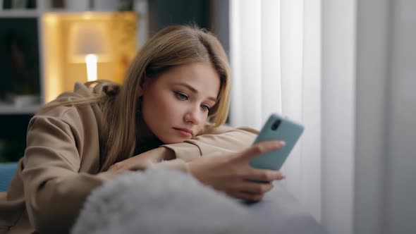 Lonely Woman Using Smartphone Couch