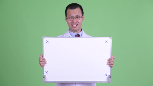 Stressed Asian Man Doctor Holding White Board