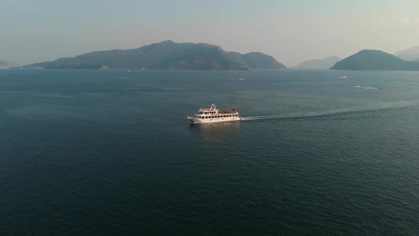 A Cruise Ship Sails in the Bay Against the Backdrop of Mountains or Fjord. Cruise Ship with Tourists